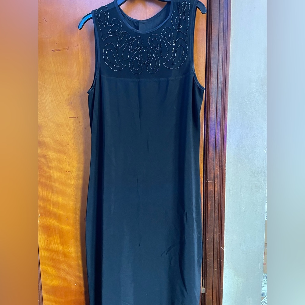 Long black dress with slit in the middle on the back. Size Medium